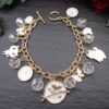 Cat Charm Bracelet: Celebrate your love for cats with our handcrafted Cat Charm Bracelet! White glass beads & adorable cat charms on a gold chain. Perfect gift for cat lovers!