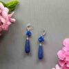Handmade blue rose teardrop earrings with natural lapis lazuli. Elegant floral dangle design, perfect for gifts or adding timeless charm to any outfit.