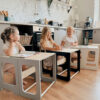 Montessori-inspired 4-in-1 kitchen helper tower with slide, table, chair and blackboard, available in multiple colours with tracked delivery across Ireland and the EU