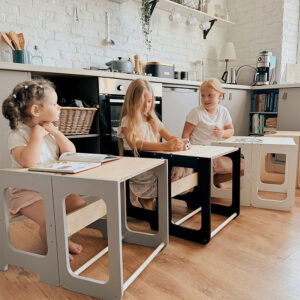 Montessori-inspired 4-in-1 kitchen helper tower with slide, table, chair and blackboard, available in multiple colours with tracked delivery across Ireland and the EU