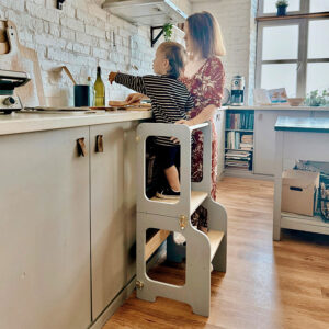 Montessori-inspired 4-in-1 kitchen helper tower with slide, table, chair and blackboard, available in multiple colours with tracked delivery across Ireland and the EU