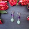 Faceted amethyst beads paired with soft green aventurine drops create these elegant, handcrafted dangle earrings. A beautiful balance of color, sparkle, and natural gemstone charm. Handmade in Ireland, gift ready, presented in a ribbon tied pillow box with Tracked An Post Delivery.