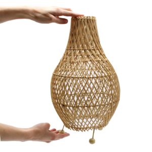 Natural base rattan table lamp casting warm patterned light in a modern bedroom setting