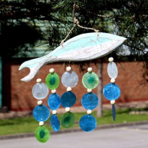 Handmade aqua fish driftwood windchime with capiz shell drops creating a soft coastal breeze sound. Coastal aqua driftwood windchime for relaxed garden spaces in Ireland.